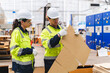 © chokniti - Professional worker team in safety uniform, supervisor inspector in packaging stock order at cardboard factory warehouse, piles of stacking paper manufacture, recycling industrial production
