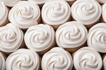 Poster - Pattern with swirled cupcakes with white whipped vanilla icing cream.Background.The concept of a holiday, party, unhealthy food.Top view, flat lay, minimalism.