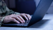 © chinnarach - close up soldier man hand type command about configuration of software to upgrade or install system in office room for military operation technology concept