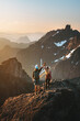 © EVERST - Couple climbing mountains together success concept romantic vacations in Norway man and woman outdoor family travel lifestyle sustainable tourism sunset landscape