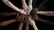 Group of multiethnic people joining hands in circle, black background. Many hands of different races and ethnicities.