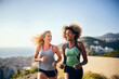 © Alfonso Soler - Two women jogging on beach promenade, embracing a fit lifestyle during summer