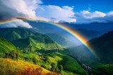 Fototapeta Tęcza - A breathtaking rainbow arching over a lush valley, with the promise of clear skies after a passing storm.
