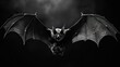  a black and white photo of a bat flying in the air with it's wings spread out and it's eyes open.