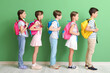© Pixel-Shot - Little pupils with backpacks near green wall