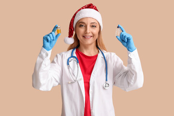 Poster - Mature female doctor in Santa hat with ampules on beige background