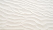 texture of close-up grooves produced by the wind that give the sand an appearance like small waves. The sand is light, slightly yellow in color