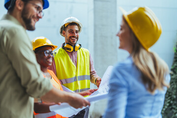 Team of civil engineer manager, maintenance supervisor, professional technician foreman together with safety operator inspect and discuss the infrastructure of building construction progress at site