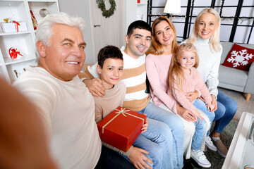 Sticker - Happy family taking selfie at home on Christmas eve