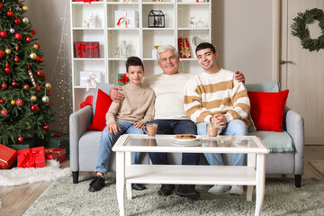 Sticker - Little boy with dad and grandfather at home on Christmas eve