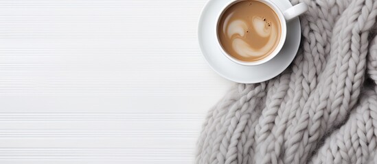 Poster - Grey knitted merino wool blanket and coffee. Space for copy. Flat lay, top view. Thick yarn. Bedroom, morning.