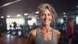 © Sintrax - Senior fit woman with gray hair smiling in a gym, radiating positivity and happiness while enjoying her workout session. Healthy lifestyle concept.