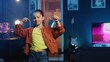 canvas print picture - Close up shot of energetic joyful kid doing charming dance moves for social media platform, following viral challenge. Joyous child recording video for online followers in dimly lit house