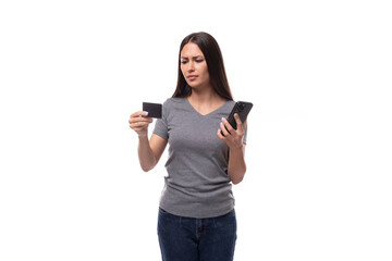 Wall Mural - caucasian slim young woman uses online money account in smartphone