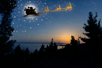 Wall Mural - a Santa Claus flies against the background of the moon on Christmas Eve