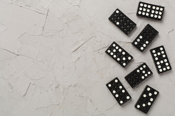 Wall Mural - Black domino tiles on concrete background, top view