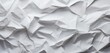 Explore the intriguing close-up of a background made of crumpled white paper, offering an abstract yet captivating space with ample copy space. The texture invites you to contemplate its unique form.
