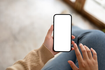 Close-up image of a woman using her smartphone while relaxing indoors. social media, mobile apps
