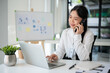 © bongkarn - Businesswoman having a phone call with her customer while working in the office room.