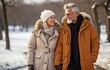 © tongpatong - A sophisticated elderly couple strolling in the snowy park by the river .