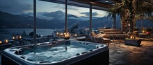Elegant Hot Tub Indoors With A Stunning Nighttime View Of The Winter Scenery.