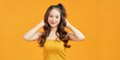 © makistock - Asian woman with a beautiful face and fresh, smooth skin is dressed in vivid yellow