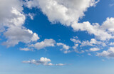Fototapeta Niebo - Sunny sky abstract background, beautiful cloudscape, on the heaven, view over white fluffy clouds, freedom concept. Aerial view of sky and white clouds. View from airplane.