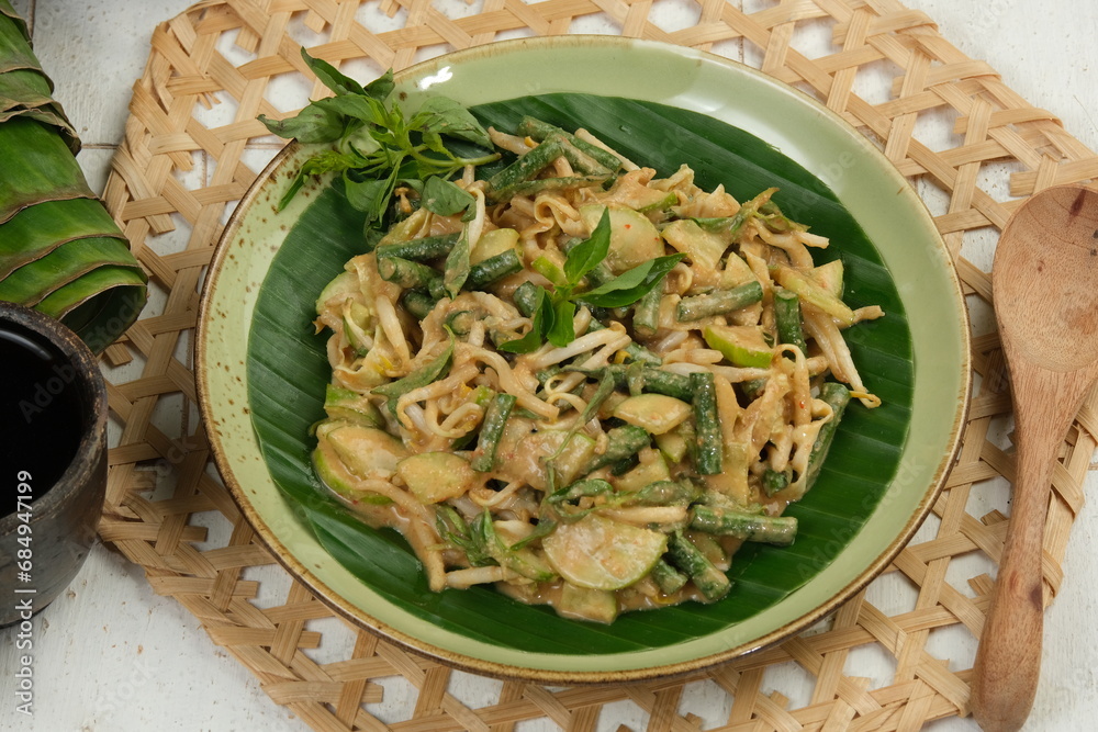 Karedok or keredok is raw vegetables salad covered in spicy peanut ...