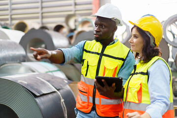 Team of mechanical engineer working together in the factory, engineers inspecting a metal machine system the factory.