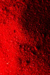 Vertical image of close up of red powder with copy space background