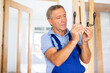 Professional door installer checks the operation of bronze door handles