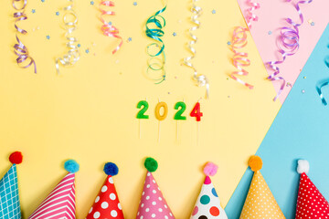 Wall Mural - 2024 party theme with with hats and streamers on a vibrant background