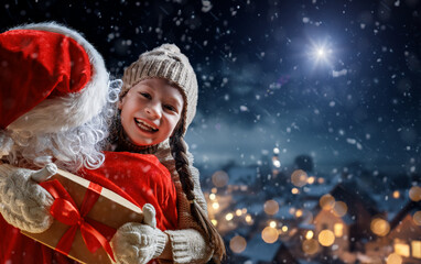 Wall Mural - child girl and Santa Claus with gift