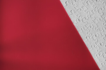 Wall Mural - Clean puzzle elements on the red background. Empty puzzle piece on the table. Teamwork concept.