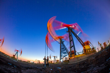 In the evening, oil pumps are running, Silhouette of beam pumping unit