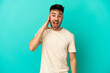 © luismolinero - Young caucasian man isolated on blue background with surprise and shocked facial expression
