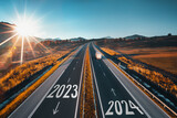 Fototapeta Do pokoju - Driving on open road at beautiful sunny day to new year 2024. Aerial view