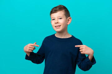 Wall Mural - Little kid boy isolated on blue background proud and self-satisfied