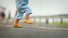 Close Up Leg Of Infant Baby Learning To Walking First Step On Pathway