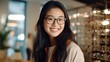 © CStock - Satisfied Asian mature woman chooses and tries on glasses