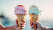 On both sides, children's hands hold a waffle cone with a scoop of pink and mint ice cream, against a blurry background of the sea. Symbol of summer holidays, holidays at sea