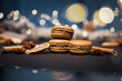Chocolate macarons cookies among pieces of dried orange on a dark background with soft light from behind