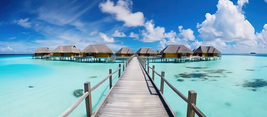 Poster - Exotic summer getaway stunning Maldives with tropical landscapes wooden bridge water villas and beautiful island beaches copy space image