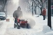 © photolas - A man clears snowdrifts with a snow blower on a city street on a winter day.