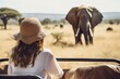 Woman tourist on a safari in Africa, traveling by car with an open roof. AI Generated