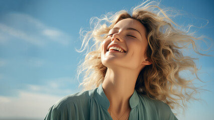 A Blonde woman breathes calmly looking up isolated on clear blue sky