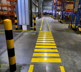 Industrial building corridor painted yellow between parallel yellow lines on abstract cement background. Sidewalk Negotiation Safety Concept	