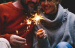 Man and woman in relationship celebrate together anniversary with sparkler lights in outdoors leisure activity. Romance and romantic people celebrating love. Concept of romanticism and love together
