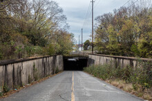 Decrepit Road Going Under A Railroad Overpass In The Deep Rural South