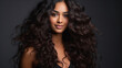 photography of Beautiful Indian girl with long shiny curly hair . Beautiful smiling woman model wavy hairstyle . Cosmetology, cosmetics and make-up.